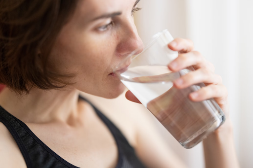 https://unsplash.com/photos/woman-in-black-tank-top-drinking-water-PcU17evKnew